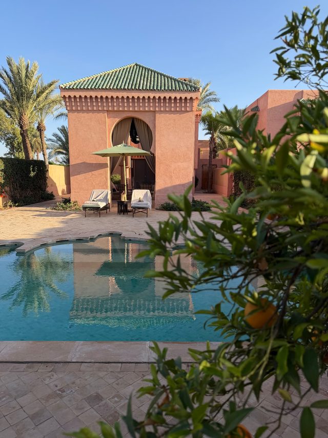 Private pool and terracotta pavilion villa at a luxury hotel in Marrakech, Morocco.