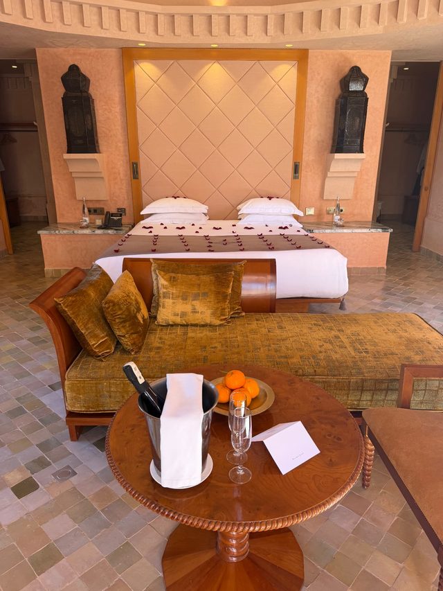 Luxury hotel suite in Marrakech with rose petals, champagne and Moroccan lanterns.