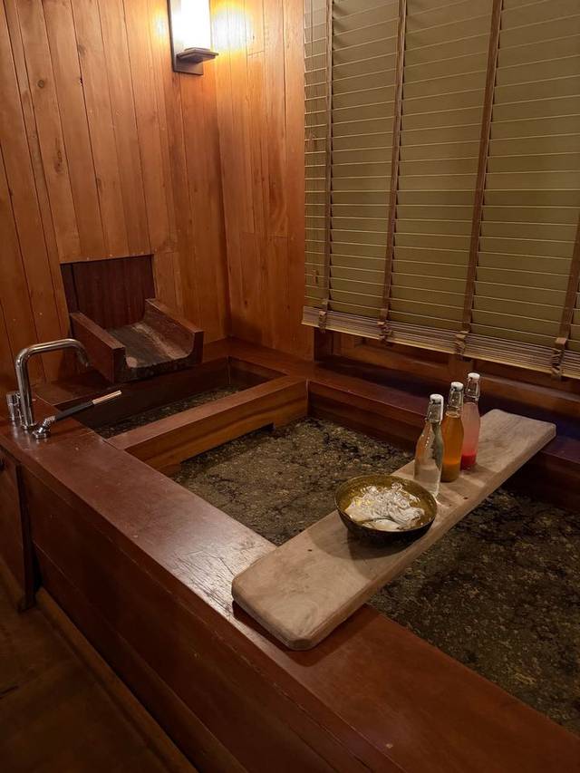 Traditional Bhutanese hot stone bath at Six Senses Thimphu, in a timber-lined room with refreshments. Traditional Bhutanese hot stone bath at Six Senses Thimphu, in a timber-lined room with refreshments.