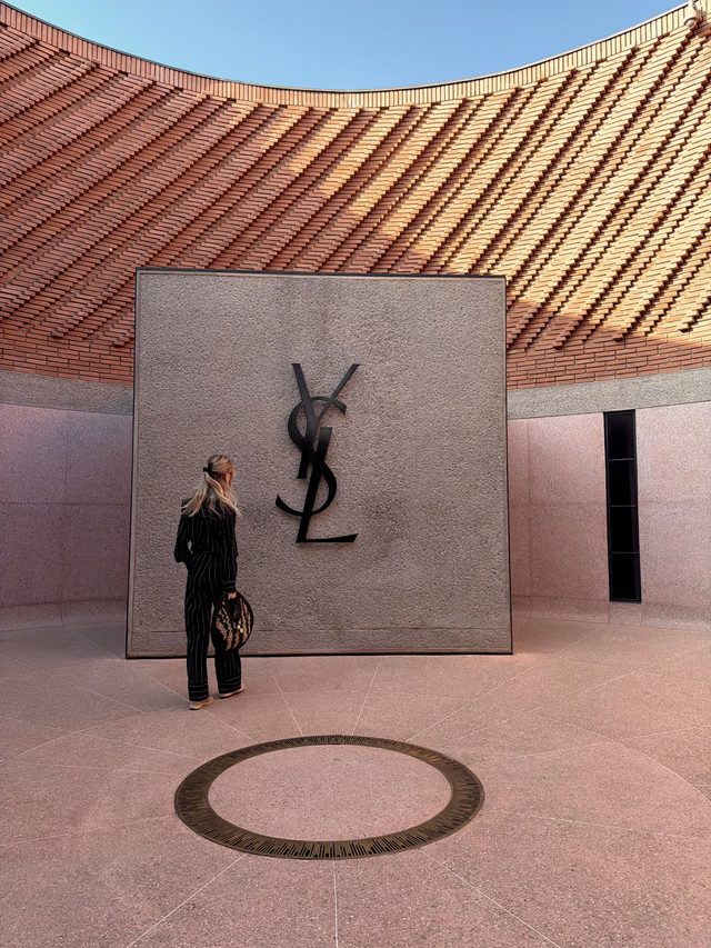 Curved terracotta brick courtyard of the Yves Saint Laurent Museum in Marrakech, Morocco.