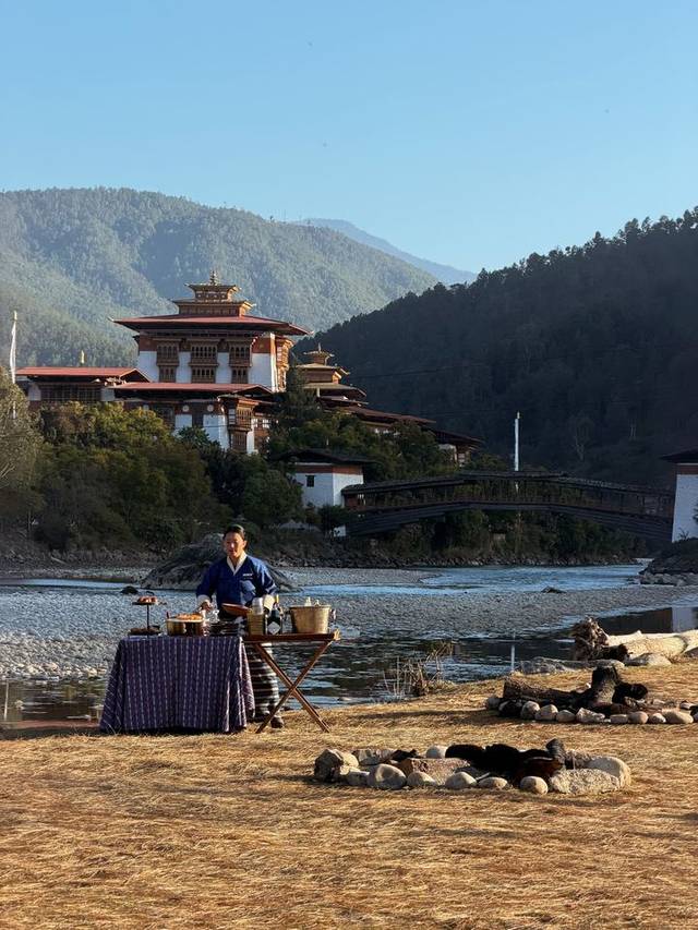 Private riverside breakfast below Punakha Dzong and its cantilever bridge, Punakha, Bhutan.