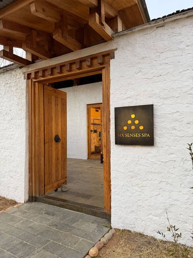 Entrance to the Six Senses Spa in Thimphu, Bhutan, with carved timber doorway and whitewashed walls. Entrance to the Six Senses Spa in Thimphu, Bhutan, with carved timber doorway and whitewashed walls.
