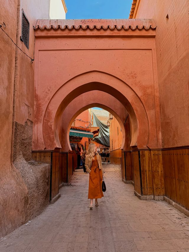 Luxury travel advisor Eva Szoradi beneath a Moorish archway leading into the Marrakech souks.