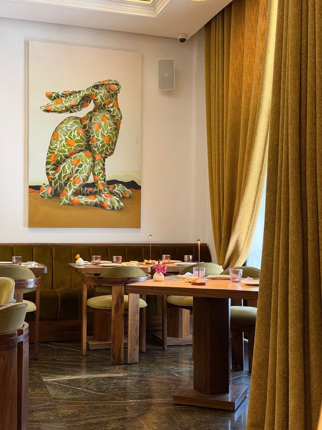 Design restaurant interior with velvet banquettes and contemporary art in Marrakech.