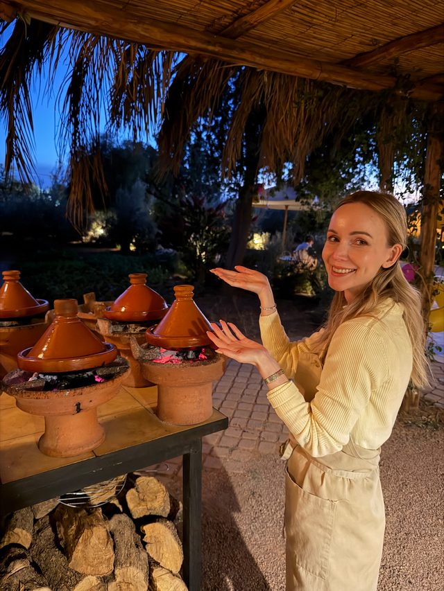 Eva Szoradi at a tagine cooking class in a garden setting near Marrakech, Morocco.